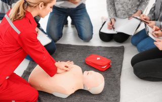 CPR Works of Charlotte Classes. Students take notes on CPR instructor.